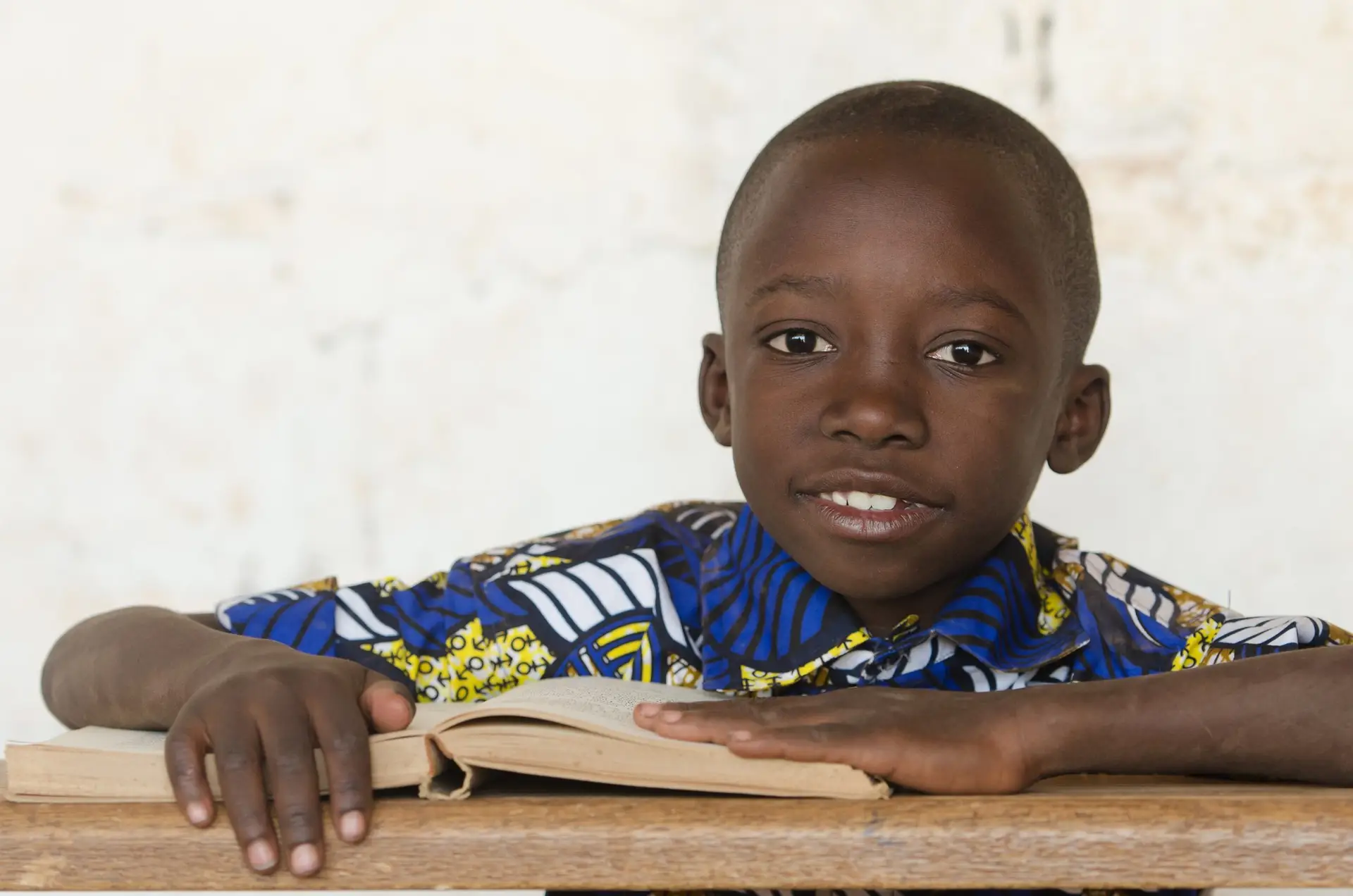 Handsome African black boy studying a Book