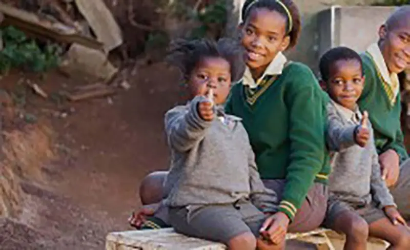 Four african kids gladly smiling on a picture